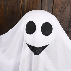 Hanging Halloween glowing ghost decoration with white mesh and black face on wood