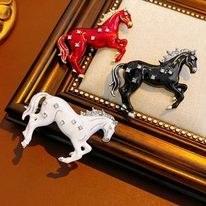 Macro shot of three vintage horse brooches with colorful enamel and sparkling rhinestones