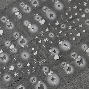 Macro detail of ultra-thin flexible nail stickers with butterflies and star designs