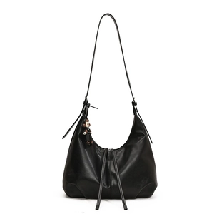 Minimalist black leather pleated hobo shoulder bag with a cute monkey pendant charm