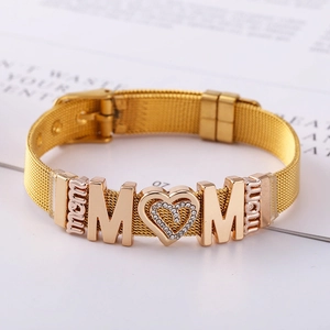 Golden mesh band bracelet featuring MOM lettering and a sparkling heart pendant charm