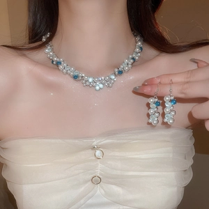 Close-up of elegant oval pearl and diamond necklace set on a model's neck