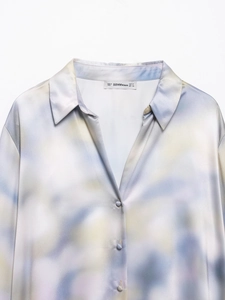 Detail of the tie-dye satin shirt neckline showing the brand label and size tag clearly