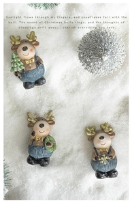 Detailed overhead shot of three resin Christmas reindeer on artificial snow background