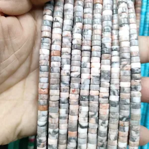 Macro detail of natural gray and pink stone rondelle spacer beads for DIY jewelry making