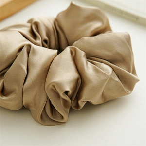 Champagne silk oversized scrunchie with high elasticity and elegant glossy texture