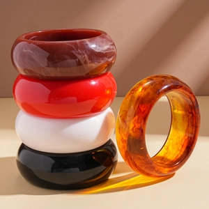 Retro thick resin bangles in amber, ivory, and red with a polished geometric round finish