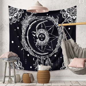 Bohemian tapestry featuring celestial sun, moon, and dreamcatcher patterns on black fabric