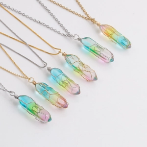 Macro detail of colorful gradient crystal pendants with gold and silver wire wrapping