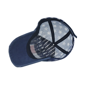 Detail view of washed denim baseball cap featuring white star mesh and American flag label