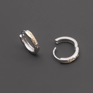 Minimalist silver ear hoops with golden flame textures and textured metallic finish