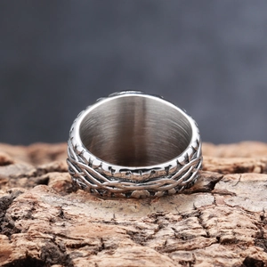 Detailed view of Viking style vine texture on a durable stainless steel band ring