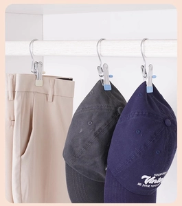 Detail of stainless steel hook clips with silicone padding hanging pants and caps