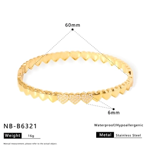 Detail view of heart-shaped gold stainless steel bracelet with white zircon inlay