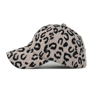 Detail of pink leopard print baseball cap featuring textured knit fabric and curved brim