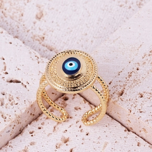 Detail of gold evil eye open ring with blue enamel and twisted rope band texture