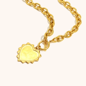 Detail of 18K gold plated stainless steel O-chain necklace with heart pendant and OT toggle clasp