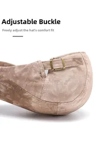 Macro detail of the vintage bronze metal adjustment buckle on the light brown newsboy cap