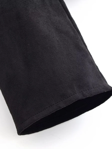 Close-up of black suede fabric and precision stitching on the fashionable bow top sleeve
