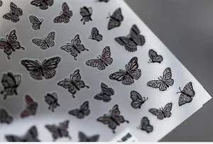 Detailed macro shot of 5D embossed butterfly nail art stickers with 3D texture