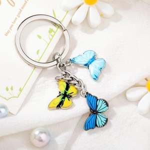 Detailed view of silver alloy keychain with three colorful enamel butterfly charms