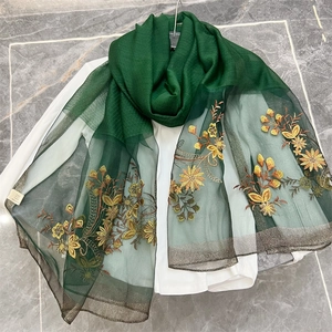 Detail of dark green floral embroidery on lightweight semi-transparent silk blend scarf