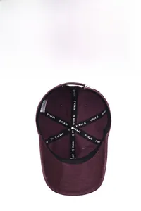 Inside view of soft top baseball cap showing brand webbing and metal adjustment buckle