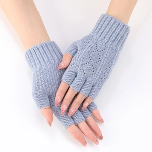 Close-up of light blue knitted fingerless arm warmers showing diamond hollow pattern