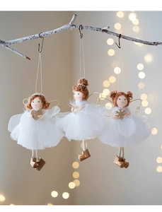 Detail of three angel dolls on tree branches with tulle skirts and golden boots