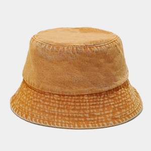 Macro shot of amber washed denim bucket hat showing vintage texture and stitching
