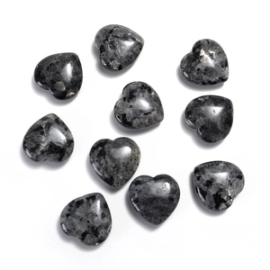 Polished 20mm heart-shaped labradorite natural gemstones scattered on white background