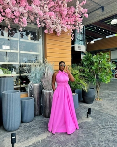 Detail of rose pink sleeveless maxi dress featuring a halter collar and large A-line skirt
