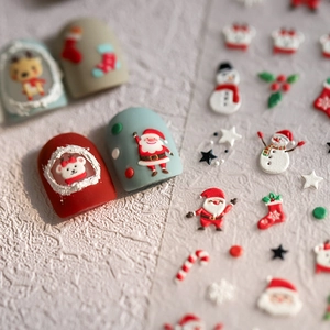 Christmas nail art stickers featuring 3D Santa, reindeer, and snowflakes for festive manicures