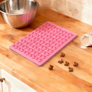 100-cavity pink silicone rabbit mold on a wooden table for DIY chocolate and gummy candy