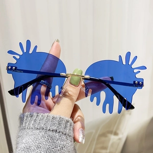 Retro teardrop splash shaped rimless sunglasses with blue lenses and gold metal nose bridge