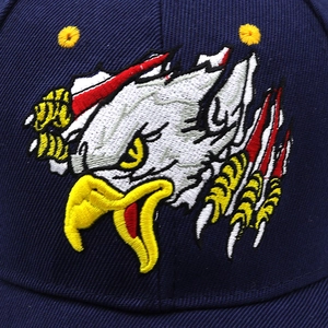 Macro shot of 3D eagle head embroidery on navy blue cotton twill baseball cap