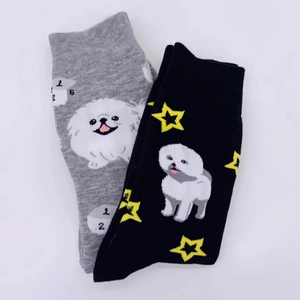 Detail of knit cotton socks with cute cartoon dog and star patterns in grey and black