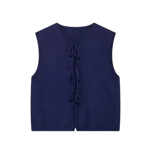 Dark blue v-neck knit vest featuring crochet texture and triple bow tie closures