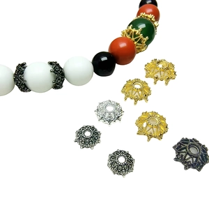 Assorted alloy hollow flower spacer beads for DIY jewelry making on white background