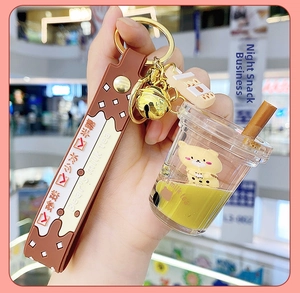 Detailed shot of cartoon bear liquid milk tea keychain with yellow oil and silicone strap