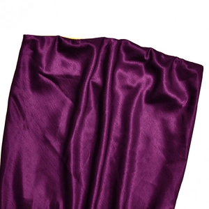 Close-up of premium purple satin fabric with elegant folds and glossy texture details