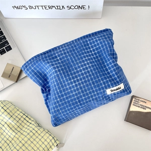 Detail of blue and yellow plaid makeup bags with metal zipper and brand label