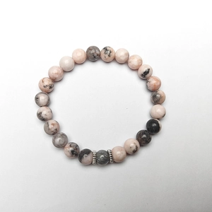 Detailed macro view of beaded bracelet with pink, grey, and black natural stones