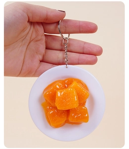 Detailed view of realistic fake food keychain with corn cubes and silver key ring attachment
