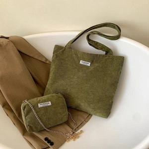 Detail view of army green corduroy tote bag with chain wallet and fashion logo