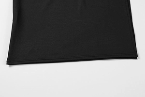 Detail of double-needle hem stitching and texture on a black slim-fit bodycon dress
