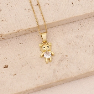 Detailed close-up of a gold bear pendant necklace with a sparkling round zircon stone