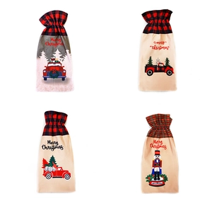 Close-up of four festive Christmas wine bottle covers with Merry Christmas print