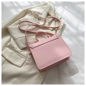 Detailed top view of pink PU leather crossbody bag with top handle and shoulder strap