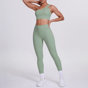 Detail of one-shoulder morandi green yoga set with high-waisted leggings and sports bra